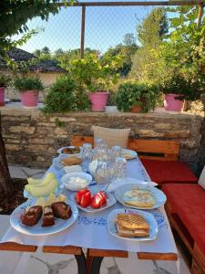 a table with plates of food on top of it at Guest House Bala in Gjirokastër