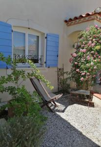 a bench in front of a house with a window at Bastide YSATIS in Coulobres
