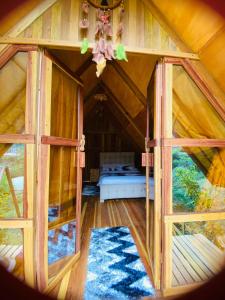 a room in a tree house with a bed in it at Gemma Eco-Glamping in Baños