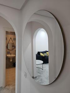 a mirror on a wall in a living room at Chic Apartment Near the Sea in Yasmine +7 photos