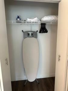 a toilet in a room with a shelf above it at Modern King Suite Downtown Walkable Pool & Gym in Wilmington