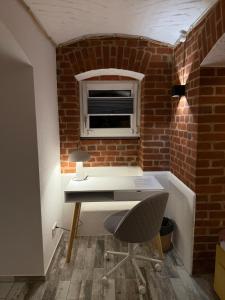 a brick walled office with a desk and a chair at Boho & Loft 2 Zimmer Parkplatz in Bad Hersfeld +48 photos
