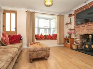 a living room with a couch and a fireplace at Christlow Cottage in Bridlington