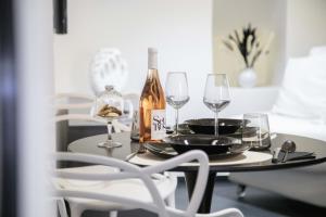 a table with glasses and a bottle of wine at Suite Piazza Vittorio Emanuele in Mesagne +31 photos
