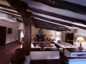 a living room with a couch and a fireplace at Mas Salvi Country Boutique Hotel in Pals