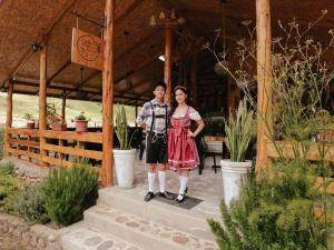 a man and a woman standing in front of a building at La Arboleda Oxapampa in Oxapampa