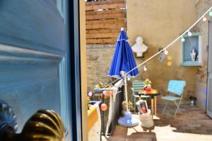 a patio with an umbrella and a table and chairs at LIBERA IDEA Art run space in Civitanova Alta