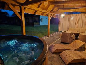 a hot tub on a patio with a table and chairs at Kasi Polany in Polany