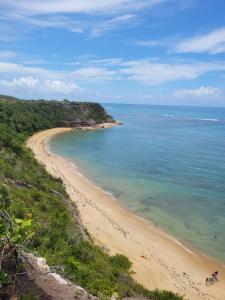 a view of a beach with the ocean at Pousada Imperador do Espelho in Praia do Espelho