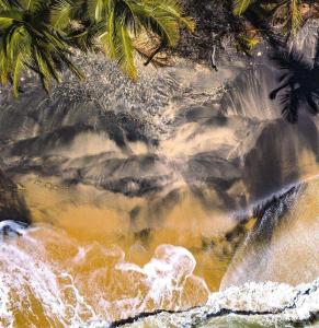 an aerial view of a waterfall and water at Pousada Imperador do Espelho in Praia do Espelho