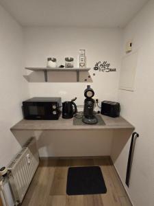 a kitchen with a counter with a toaster and a microwave at M&D ISKA Vermietung w4 in Heide