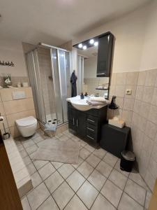 a bathroom with a sink and a toilet and a mirror at M&D ISKA Vermietung w4 in Heide