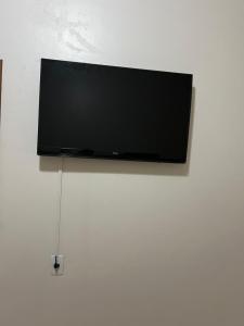 a flat screen tv hanging on a wall at Suíte privativa in Novo Hamburgo +4 photos