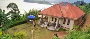 a small house on a hill with a view of a river at Wycliffˋs Eco Lodge in Kabale