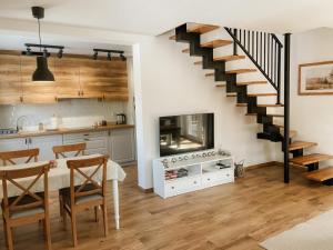 a kitchen and dining room with a spiral staircase at Kasi Polany in Polany