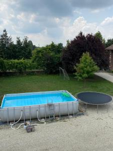 a swimming pool with a table and a ping at Agriturismo AgriTexS in Savigliano