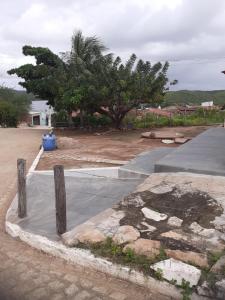 a concrete sidewalk with a tree in the background at Casa Menezes - Ilha do Ferro - Alagoas in Pão de Açúcar