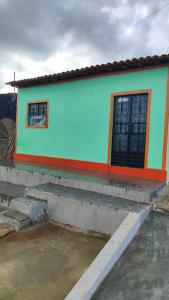 a colorful house with a staircase in front of it at Casa Menezes - Ilha do Ferro - Alagoas in Pão de Açúcar