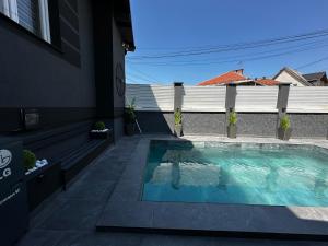 a swimming pool in the backyard of a house at Vila CITY by BEN&CO in Sarajevo