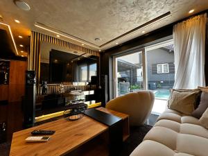 a living room with a couch and a table at Vila CITY by BEN&CO in Sarajevo