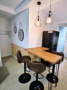 a dining room with a wooden table and chairs at El Andén de Garrido sin ascensor in Salamanca +9 photos