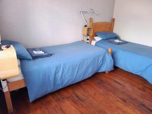two beds sitting next to each other in a room at Littleholme in Potter Heigham