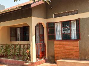 a house with red doors and a fence at Kylo cozy calm in Kampala