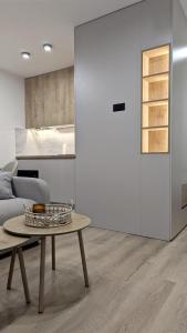 a living room with a table and a kitchen at Cozy apartment in Podgorica in Podgorica