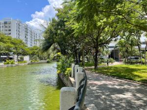 a park with a bench next to a river at Casa de LYN Nha Trang in Nha Trang
