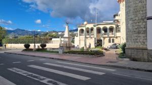 a large building with a crosswalk in front of a street at Dulce Hogar 01 in Loja