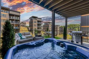 a hot tub on the patio of a apartment at Smith Creek Resort - 5 Bedrooms 20 Guest - Indoor Pool - Resort Amenities in Pigeon Forge