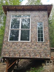 a tiny house on a pallet with a window at Camo Cabin #4 in Houston