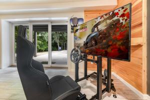 a gaming room with a monitor and a gaming chair at Stay And Play 18 Guest Family Fun - Pickleball Court in Sevierville