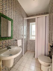 a bathroom with a sink and a toilet at Sidi Bou Said-style villa with pool in Hammamet