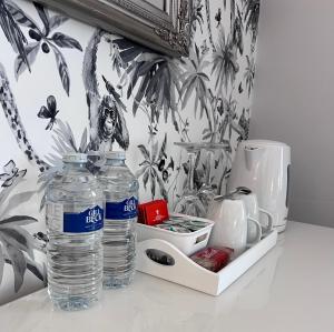 two bottles of water are sitting on a counter at Chadberry House Hotel in Blackpool