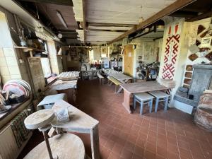 a room with tables and chairs in a store at CEPĻI Glempings in Dunte