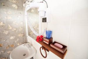 a bathroom with a white toilet and a sink at Kristal Inn Cottage Caraïbes in Capesterre-de-Marie-Galante +20 photos