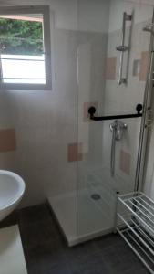 a bathroom with a glass shower and a sink at 20g rue martorez 71100 Saint remy in Saint-Rémy