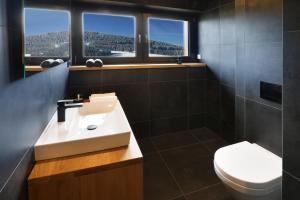 a bathroom with a sink and a toilet at Apartmány Horizont in Loučná pod Klínovcem