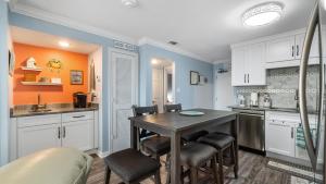 a kitchen with a table and chairs in a room at Plantation 4507 in Gulf Highlands
