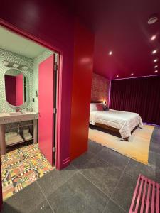 a bedroom with purple walls and a bed and a mirror at Hotel Hilo - Room 203 in Louisville