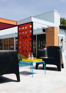a table and chairs sitting in front of a store at Hotel Hilo - Room 203 in Louisville
