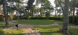 a park with palm trees and a stone path at WATO Villas in Bulindo