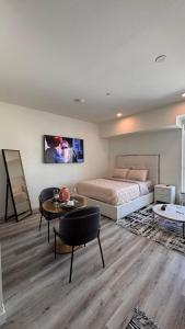 a bedroom with a bed and a table in a room at Luxury Walk of Fame Studio in Los Angeles