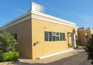 a yellow building with a sign on top of it at ebc lodge in Ndola +30 photos