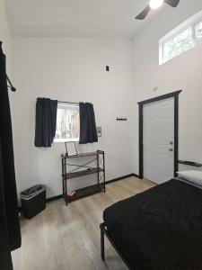 a bedroom with a bed and a window and a door at Vibing In The Woods #6 in Houston