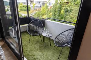 a balcony with two chairs and a small table at Stilvolles Apartment in Siegen in Siegen