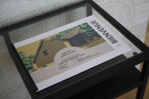 a picture of a house in a glass box at La boutique des Roches in Mondeville +6 photos
