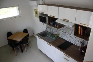 a small kitchen with a table and a counter top at La boutique des Roches in Mondeville