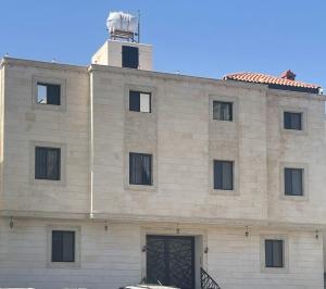 a building with a lighthouse on top of it at شقة الردف in Taif